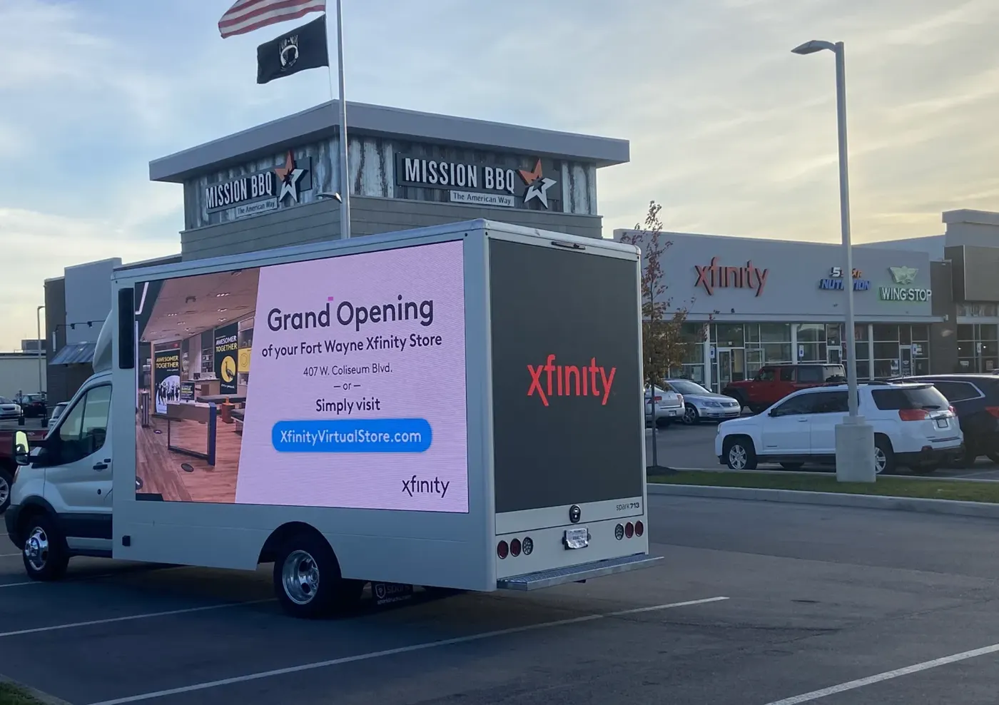 An Xfinity digital billboard truck showing “Grand Opening” and the store address outside the new Fort Wayne store